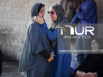 Palestinians are mourning over the bodies of loved ones  following Israeli bombardment in Deir el-Balah in the central Gaza Strip on August...