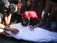 Palestinians are mourning over the bodies of loved ones  following Israeli bombardment in Deir el-Balah in the central Gaza Strip on August...