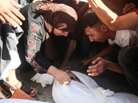 Palestinians are mourning over the bodies of loved ones  following Israeli bombardment in Deir el-Balah in the central Gaza Strip on August...