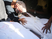 Palestinians are mourning over the bodies of loved ones  following Israeli bombardment in Deir el-Balah in the central Gaza Strip on August...