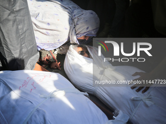 Palestinians are mourning over the bodies of loved ones  following Israeli bombardment in Deir el-Balah in the central Gaza Strip on August...