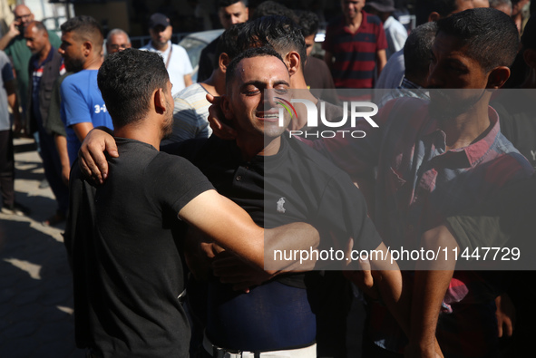 Palestinians are mourning over the bodies of loved ones  following Israeli bombardment in Deir el-Balah in the central Gaza Strip on August...