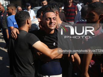 Palestinians are mourning over the bodies of loved ones  following Israeli bombardment in Deir el-Balah in the central Gaza Strip on August...