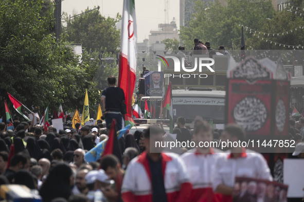 A truck carrying the coffins containing the bodies of Hamas leader Ismail Haniyeh and his bodyguard Abu Shaaban is making its way through th...