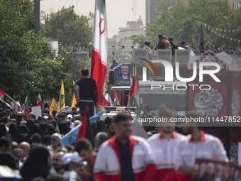 A truck carrying the coffins containing the bodies of Hamas leader Ismail Haniyeh and his bodyguard Abu Shaaban is making its way through th...