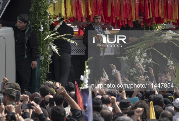 A truck is carrying the coffins containing the bodies of Hamas leader Ismail Haniyeh and his bodyguard Abu Shaaban during a funeral ceremony...