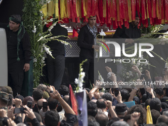 A truck is carrying the coffins containing the bodies of Hamas leader Ismail Haniyeh and his bodyguard Abu Shaaban during a funeral ceremony...