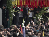 A truck is carrying the coffins containing the bodies of Hamas leader Ismail Haniyeh and his bodyguard Abu Shaaban during a funeral ceremony...