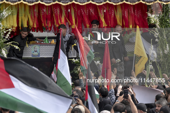 A truck is carrying the coffins containing the bodies of Hamas leader Ismail Haniyeh and his bodyguard Abu Shaaban during a funeral ceremony...