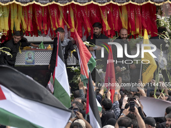 A truck is carrying the coffins containing the bodies of Hamas leader Ismail Haniyeh and his bodyguard Abu Shaaban during a funeral ceremony...