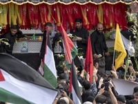 A truck is carrying the coffins containing the bodies of Hamas leader Ismail Haniyeh and his bodyguard Abu Shaaban during a funeral ceremony...