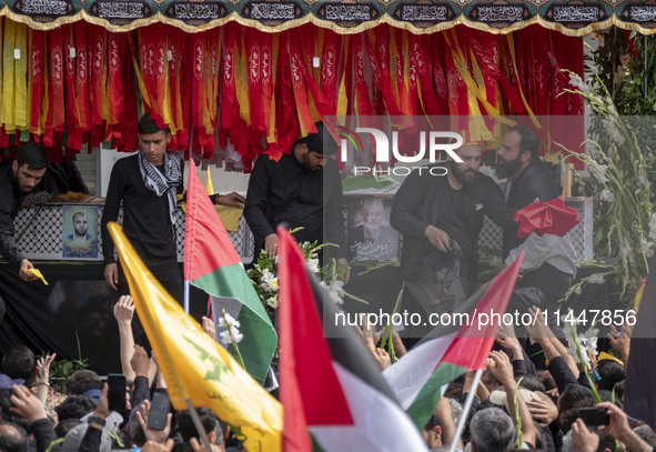 A truck is carrying the coffins containing the bodies of Hamas leader Ismail Haniyeh and his bodyguard Abu Shaaban during a funeral ceremony...