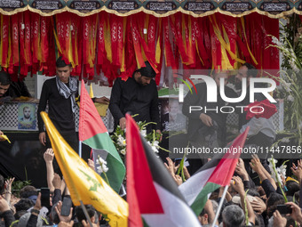 A truck is carrying the coffins containing the bodies of Hamas leader Ismail Haniyeh and his bodyguard Abu Shaaban during a funeral ceremony...