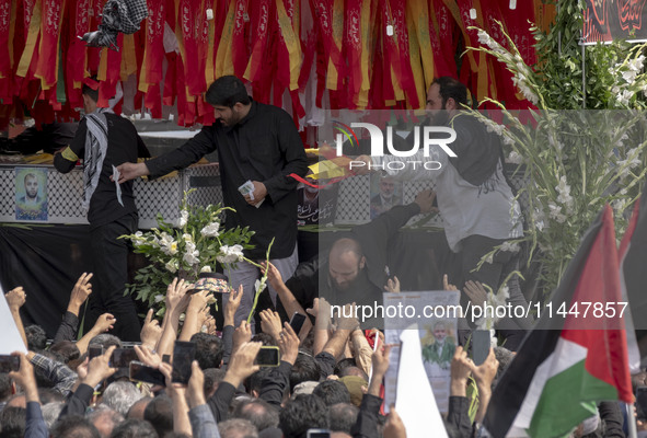 A truck is carrying the coffins containing the bodies of Hamas leader Ismail Haniyeh and his bodyguard Abu Shaaban during a funeral ceremony...