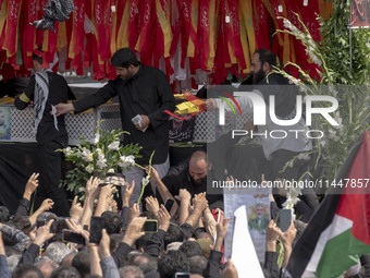 A truck is carrying the coffins containing the bodies of Hamas leader Ismail Haniyeh and his bodyguard Abu Shaaban during a funeral ceremony...