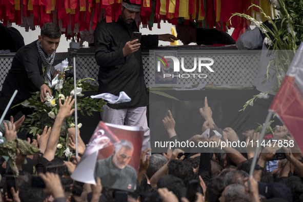 A truck is carrying the coffins containing the bodies of Hamas leader Ismail Haniyeh and his bodyguard Abu Shaaban during a funeral ceremony...