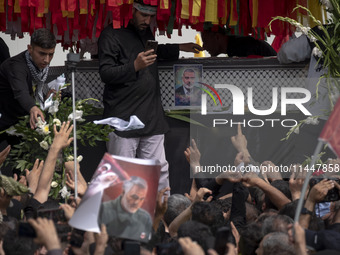 A truck is carrying the coffins containing the bodies of Hamas leader Ismail Haniyeh and his bodyguard Abu Shaaban during a funeral ceremony...