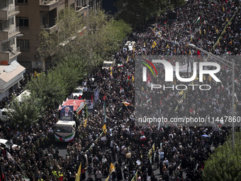 A truck carrying the coffins containing the bodies of Hamas leader Ismail Haniyeh and his bodyguard Abu Shaaban is making its way through th...