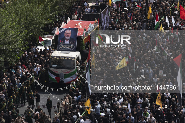 A truck carrying the coffins containing the bodies of Hamas leader Ismail Haniyeh and his bodyguard Abu Shaaban is making its way through th...