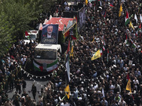 A truck carrying the coffins containing the bodies of Hamas leader Ismail Haniyeh and his bodyguard Abu Shaaban is making its way through th...