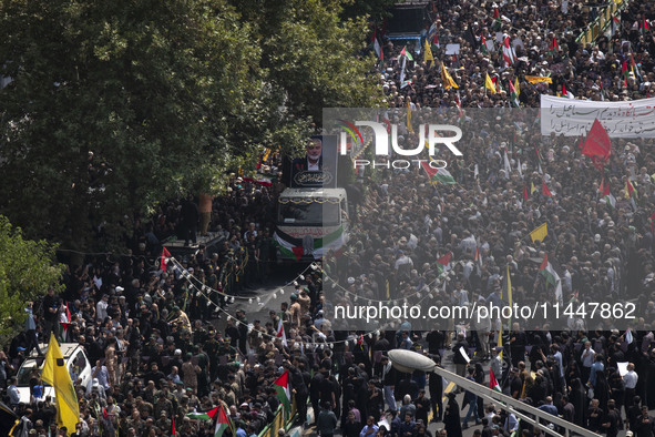 A truck carrying the coffins containing the bodies of Hamas leader Ismail Haniyeh and his bodyguard Abu Shaaban is making its way through th...