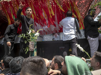 A truck is carrying the coffins containing the bodies of Hamas leader Ismail Haniyeh and his bodyguard Abu Shaaban during a funeral ceremony...