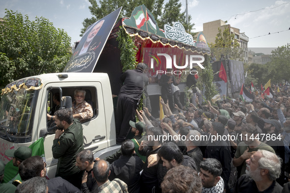 A truck is carrying the coffins containing the bodies of Hamas leader Ismail Haniyeh and his bodyguard Abu Shaaban during a funeral ceremony...