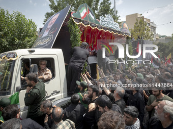 A truck is carrying the coffins containing the bodies of Hamas leader Ismail Haniyeh and his bodyguard Abu Shaaban during a funeral ceremony...