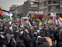 A truck is carrying the coffins containing the bodies of Hamas leader Ismail Haniyeh and his bodyguard Abu Shaaban through the crowd during...