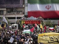 A truck is carrying the coffins containing the bodies of Hamas leader Ismail Haniyeh and his bodyguard Abu Shaaban through the crowd during...