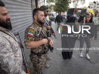 The Islamic Revolutionary Guard Corps (IRGC) armed special forces are monitoring an area during a funeral ceremony for Hamas leader Ismail H...