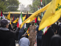 An Islamic Revolutionary Guard Corps (IRGC) military personnel is monitoring people during a funeral ceremony for Hamas leader Ismail Haniye...