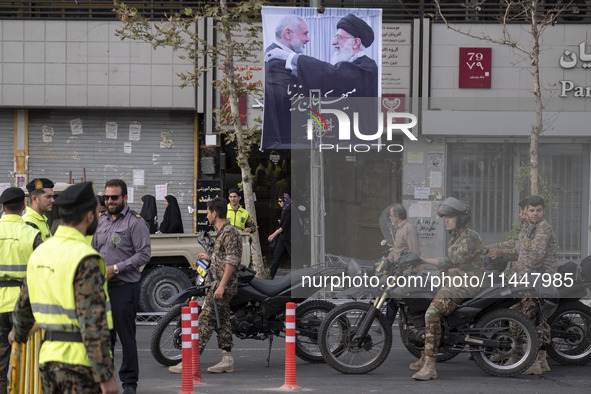 The Islamic Revolutionary Guard Corps (IRGC) armed special forces and Iranian special police forces are monitoring an area under a banner fe...