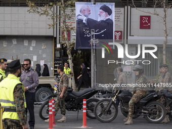 The Islamic Revolutionary Guard Corps (IRGC) armed special forces and Iranian special police forces are monitoring an area under a banner fe...