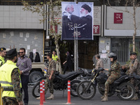 The Islamic Revolutionary Guard Corps (IRGC) armed special forces and Iranian special police forces are monitoring an area under a banner fe...