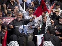 An Iranian man is shouting anti-U.S. and anti-Israeli slogans while burning an Israeli flag during a funeral ceremony for Hamas leader Ismai...