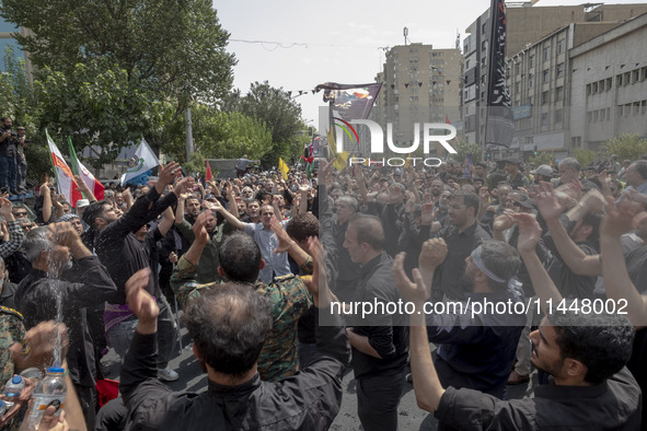 Iranian mourners are beating themselves while participating in a funeral ceremony for Hamas leader Ismail Haniyeh and his bodyguard Abu Shaa...