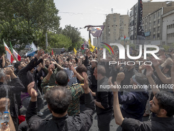 Iranian mourners are beating themselves while participating in a funeral ceremony for Hamas leader Ismail Haniyeh and his bodyguard Abu Shaa...