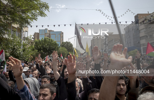 Iranian mourners are beating themselves while participating in a funeral ceremony for Hamas leader Ismail Haniyeh and his bodyguard Abu Shaa...