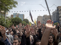 Iranian mourners are beating themselves while participating in a funeral ceremony for Hamas leader Ismail Haniyeh and his bodyguard Abu Shaa...