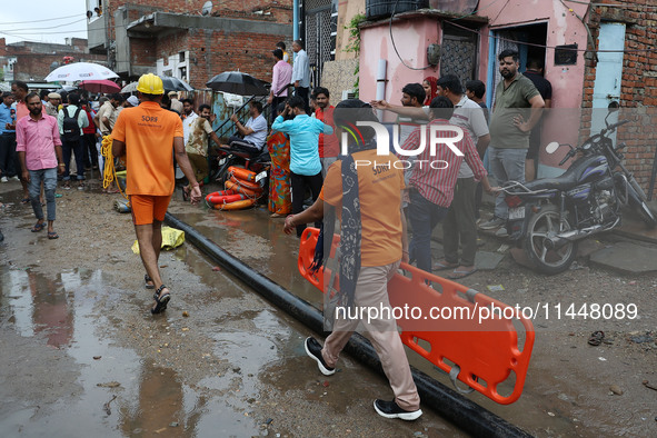 Police and SDRF personnel are conducting a rescue operation after three people drowned in rainwater that entered the basement of their house...