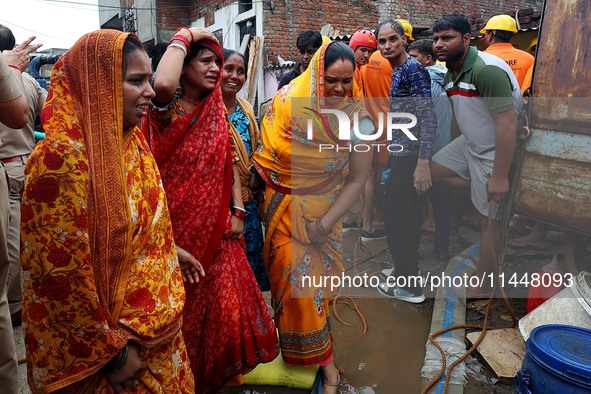 Family members are mourning after three people drowned in rainwater that entered the basement of their house due to heavy rainfall in the VK...