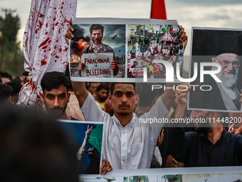 Shia devotees are condemning the killing in Parachinar as they hold Yahya Sinwar's portraits during the 25th Muharram procession in Baramull...