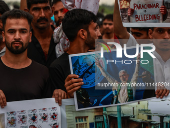 Shia devotees are condemning the killing in Parachinar as they hold Yahya Sinwar's portraits during the 25th Muharram procession in Baramull...