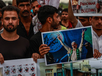 Shia devotees are condemning the killing in Parachinar as they hold Yahya Sinwar's portraits during the 25th Muharram procession in Baramull...