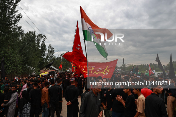 Shia devotees are raising Indian national flags during the 25th Muharram procession in Baramulla, Jammu and Kashmir, India, on August 1, 202...