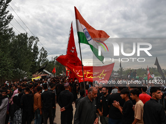 Shia devotees are raising Indian national flags during the 25th Muharram procession in Baramulla, Jammu and Kashmir, India, on August 1, 202...