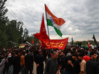 Shia devotees are raising Indian national flags during the 25th Muharram procession in Baramulla, Jammu and Kashmir, India, on August 1, 202...