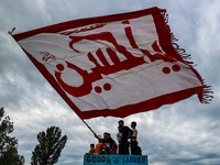 Shia devotees are raising flags during the 25th Muharram procession in Baramulla, Jammu and Kashmir, India, on August 1, 2024. (