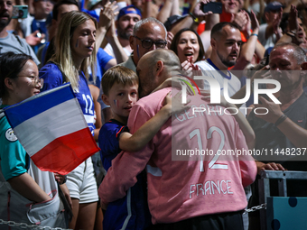 Vincent Gerard, the goalkeeper of the France team, is celebrating with his family after the men's Handball Preliminary Round - Group B match...